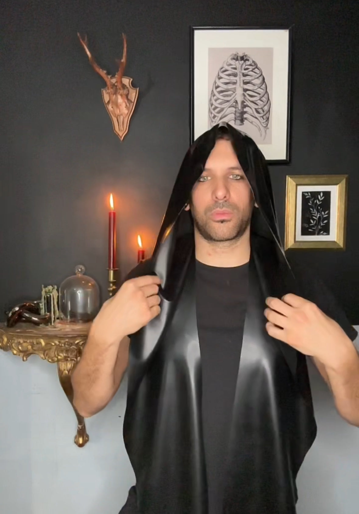 Styling of the dramatic unisex latex wrap hood layered over an outfit