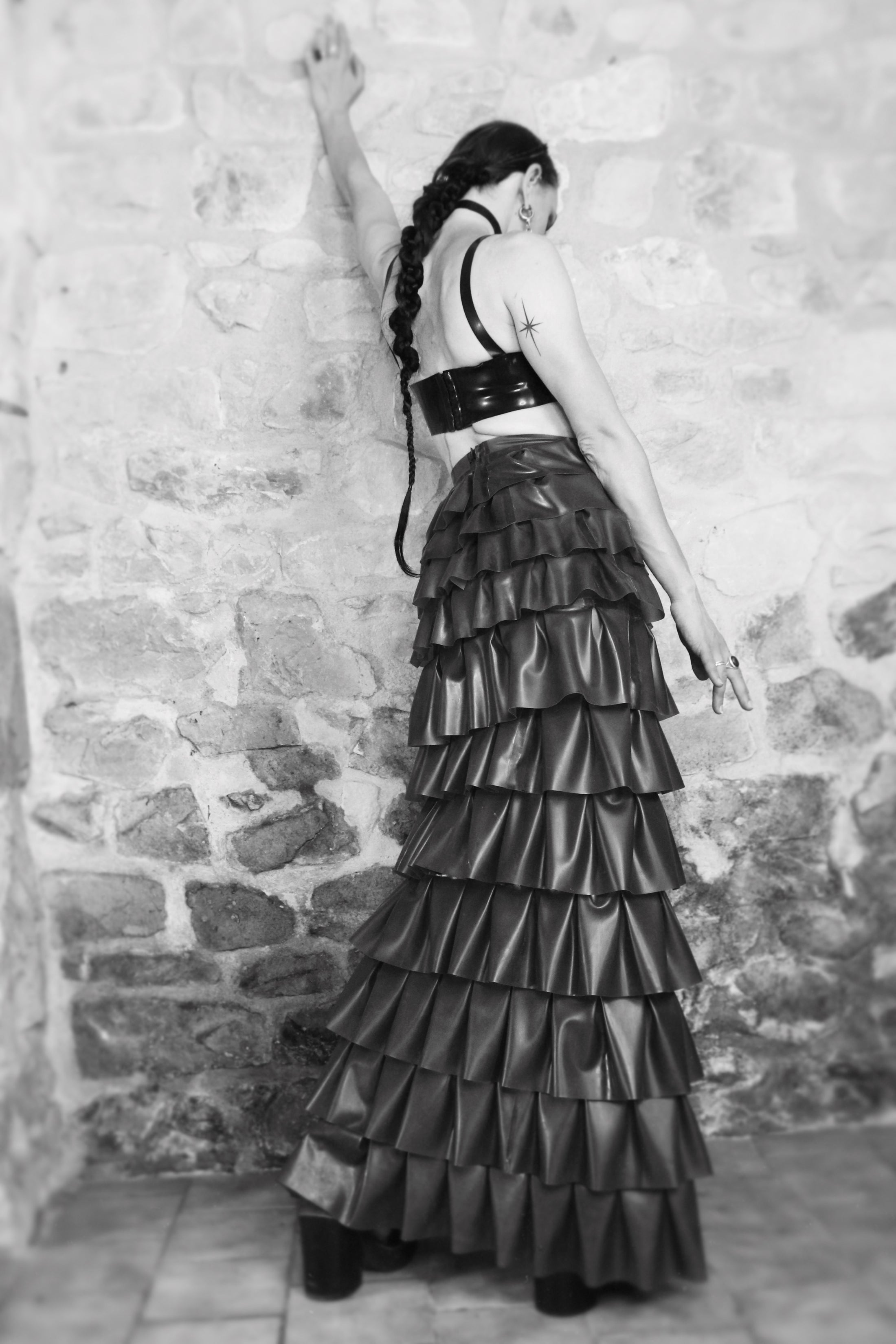 Detail of the high-low hem on the full-length latex ruffle skirt