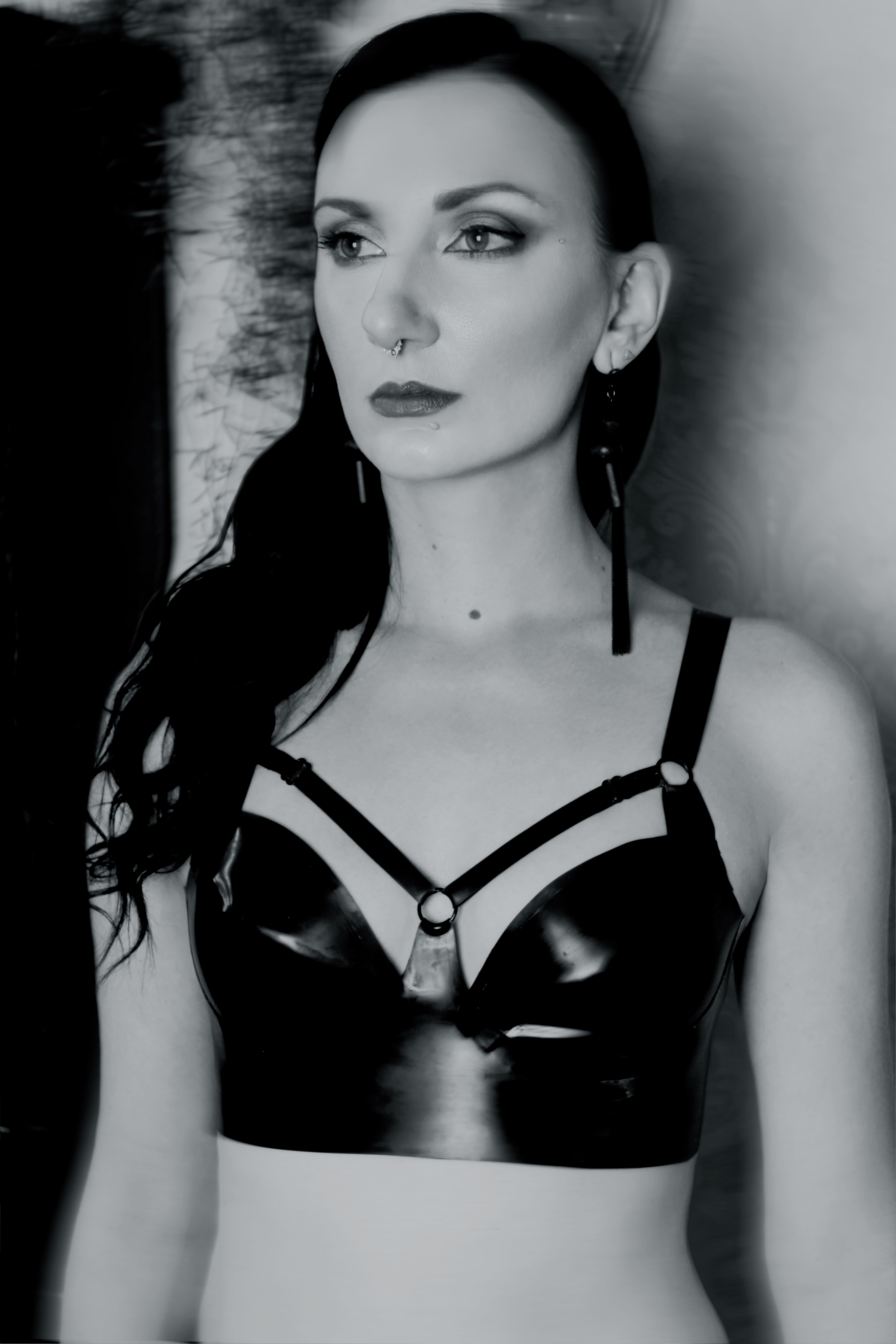 Eustratia underwired latex harness bra with adjustable straps across chest and back