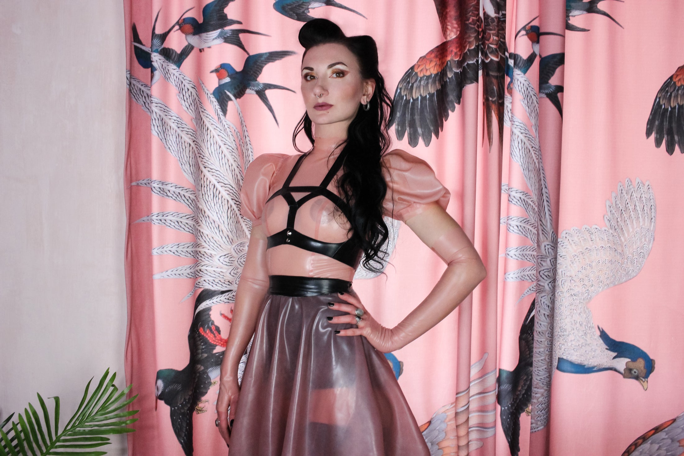 Close detail of the centre-back zip on the puff sleeve latex top