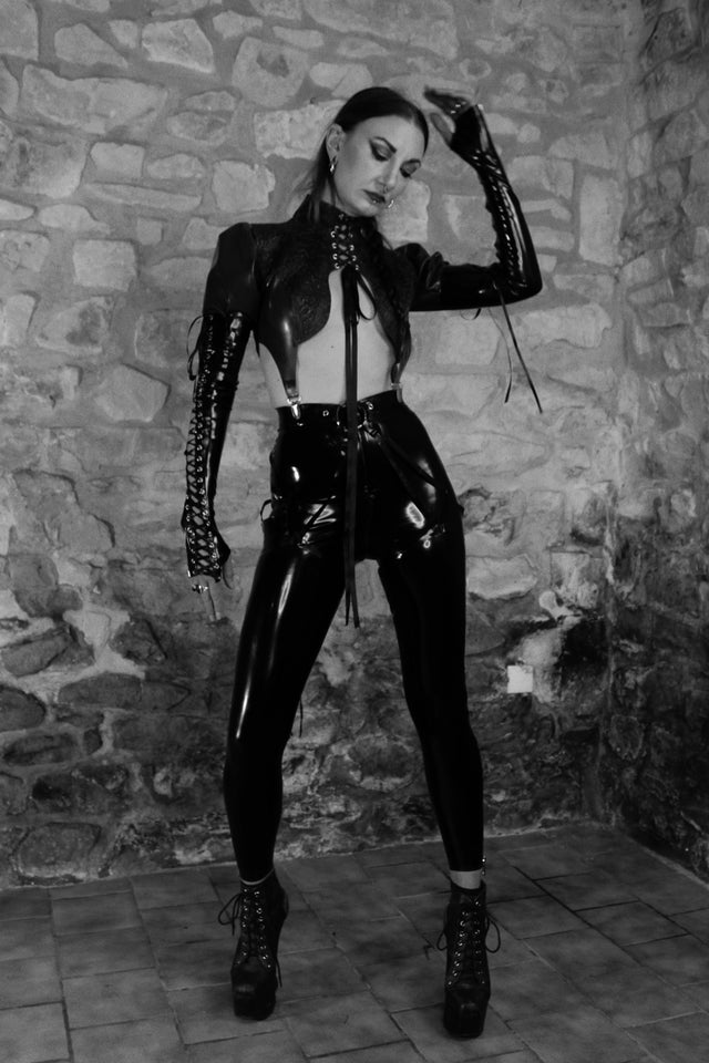 black and white picture of woman is goth latex outfit