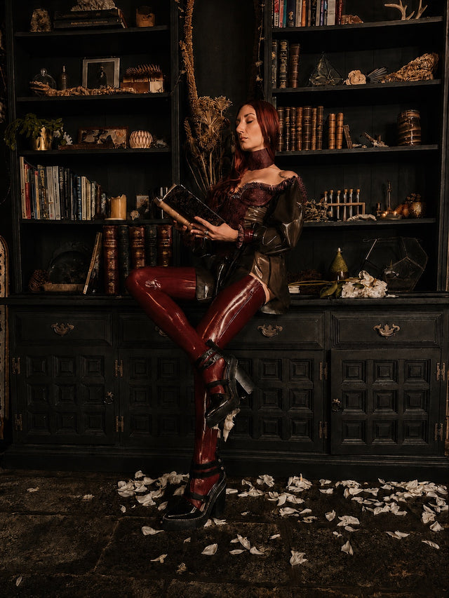 woman reading in a dark library
