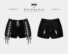 Detail of the contouring lace-up latex shorts with ribbon panel