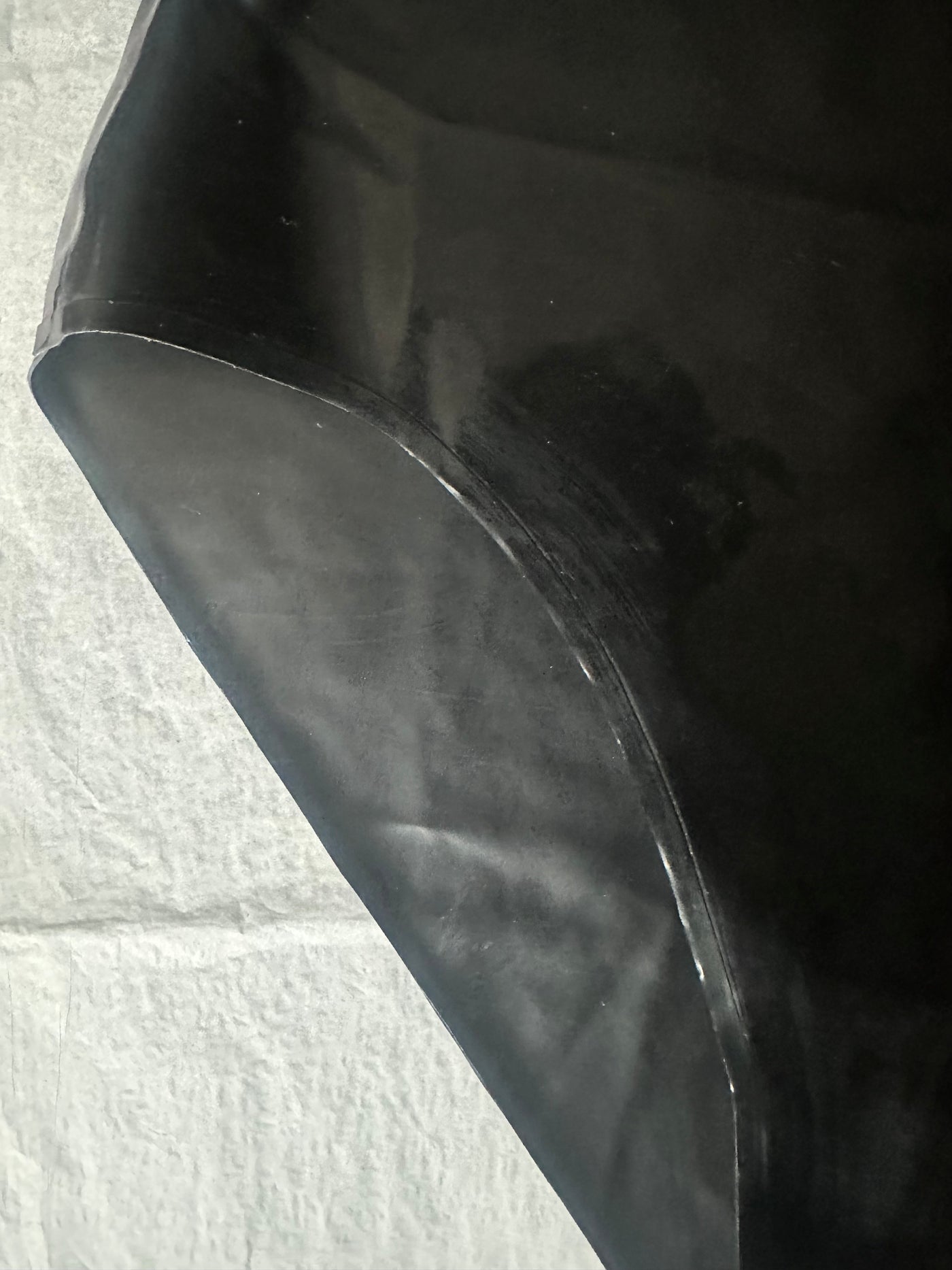 Styling of the high waisted black latex briefs with high leg fit