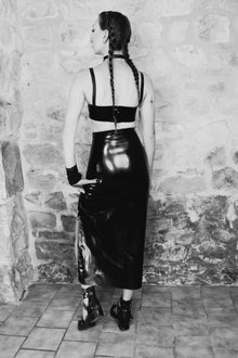 Detail of structured fetish-inspired strap layering on the latex Buckle crop top