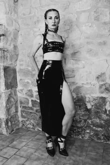 Close detail of adjustable shoulder straps and buckle fastenings on the latex Buckle crop top