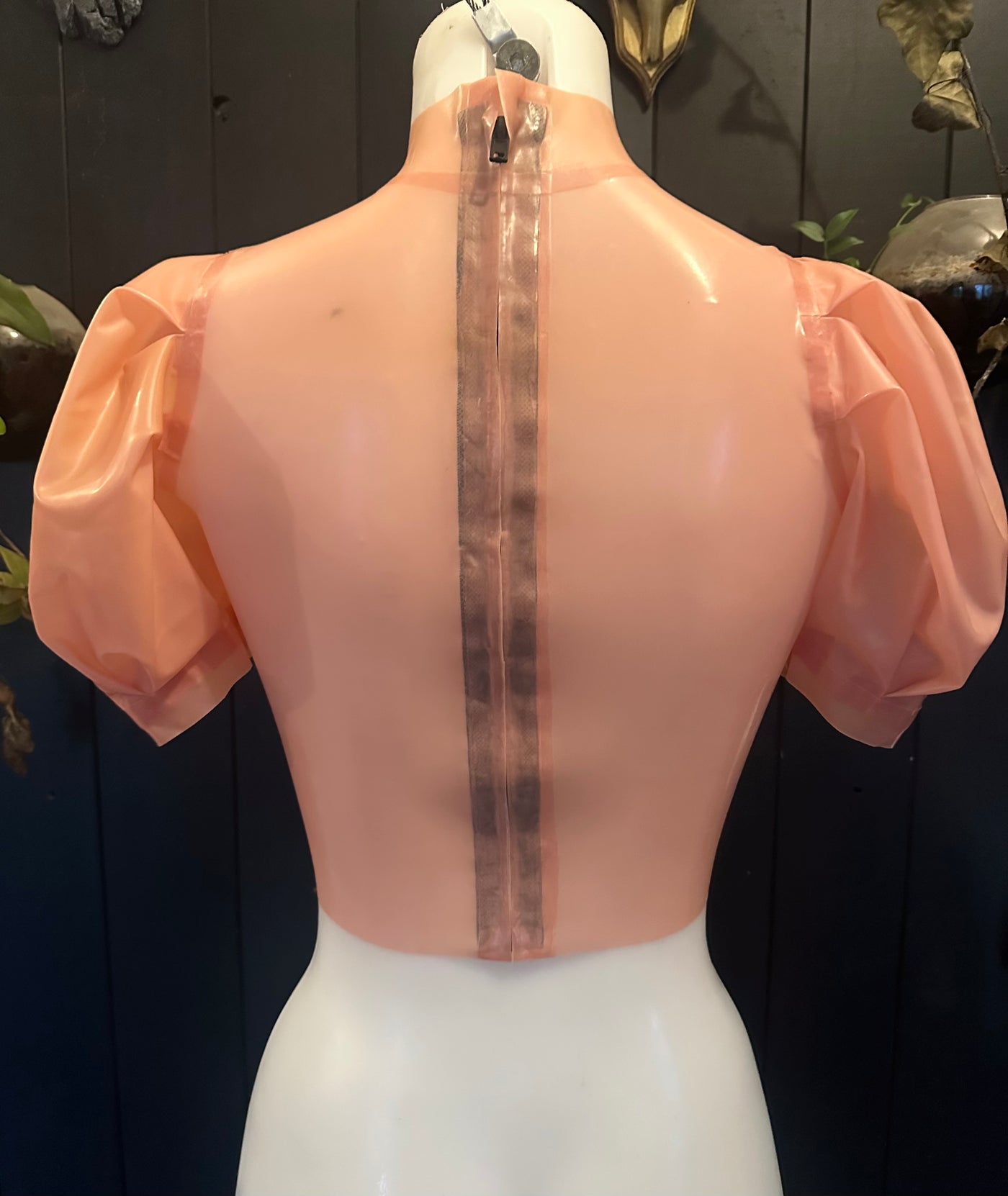 Close detail of the puff sleeves on the translucent pink latex top sample