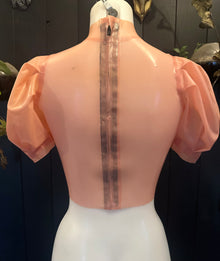 Close detail of the puff sleeves on the translucent pink latex top sample