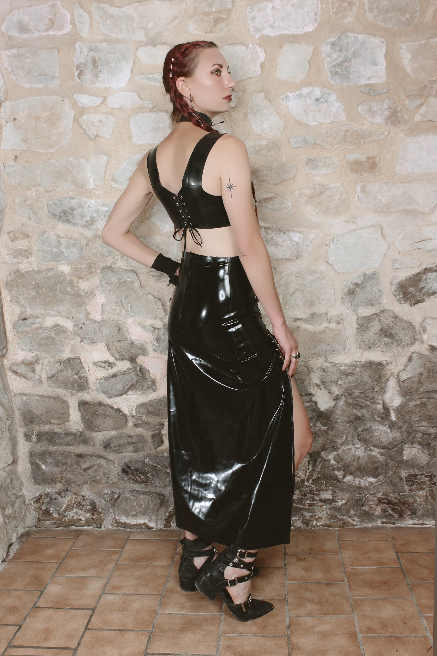 Detail of the eyelet-laced panelling on the long Lilith latex skirt