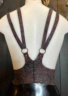 Detail of the adjustable straps and cinched fit on the latex-lace harness sample