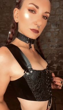 Styling of the cropped latex corset top for a period-inspired silhouette