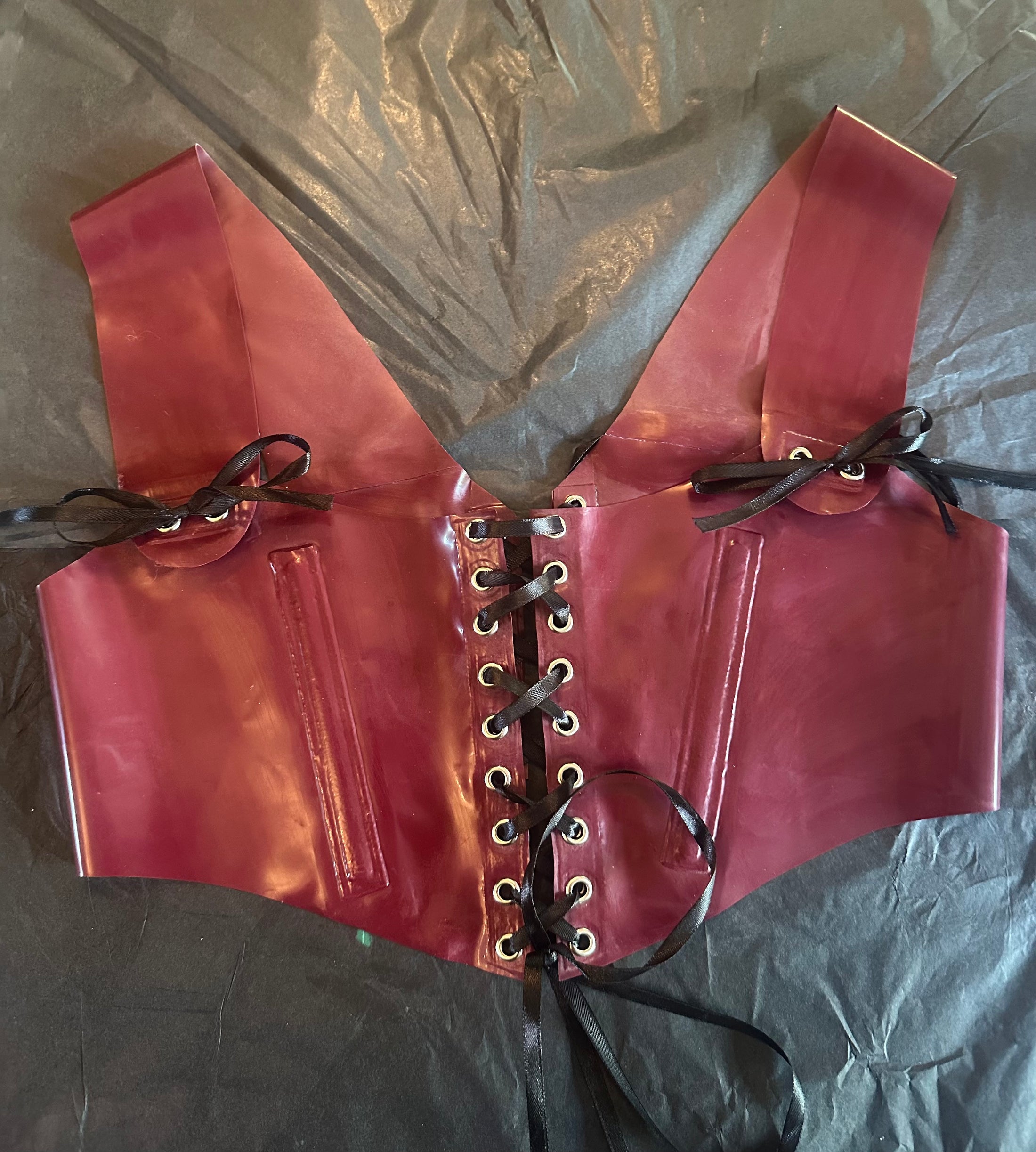 Detail of the lace-up corset lacing on the cropped latex top
