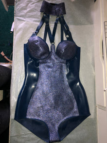 Texture detail of the blue and gold glittermesh accent panels on the V-strap bodysuit