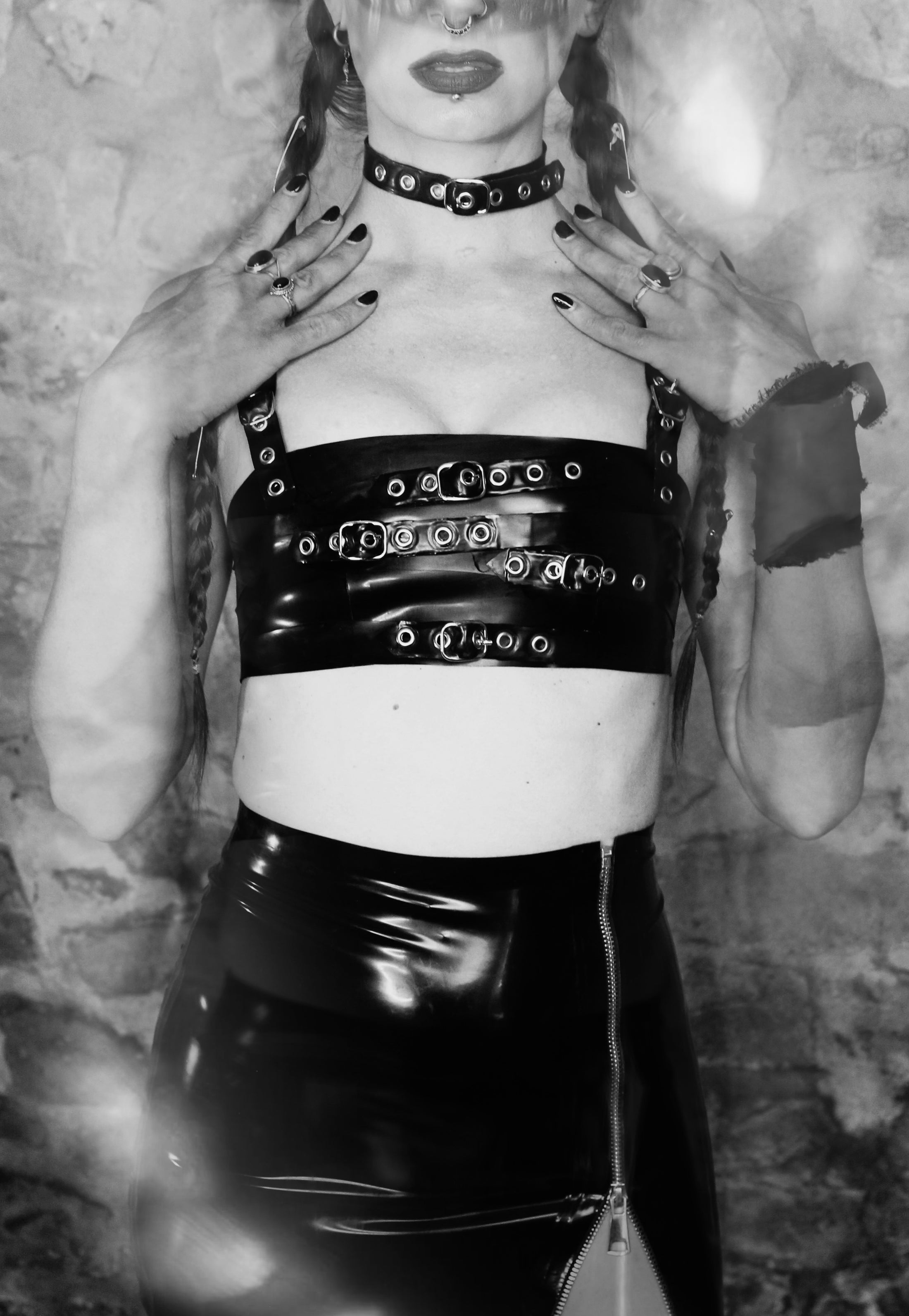 Texture detail of thicker grade natural latex and eyelet accents on the Buckle crop top
