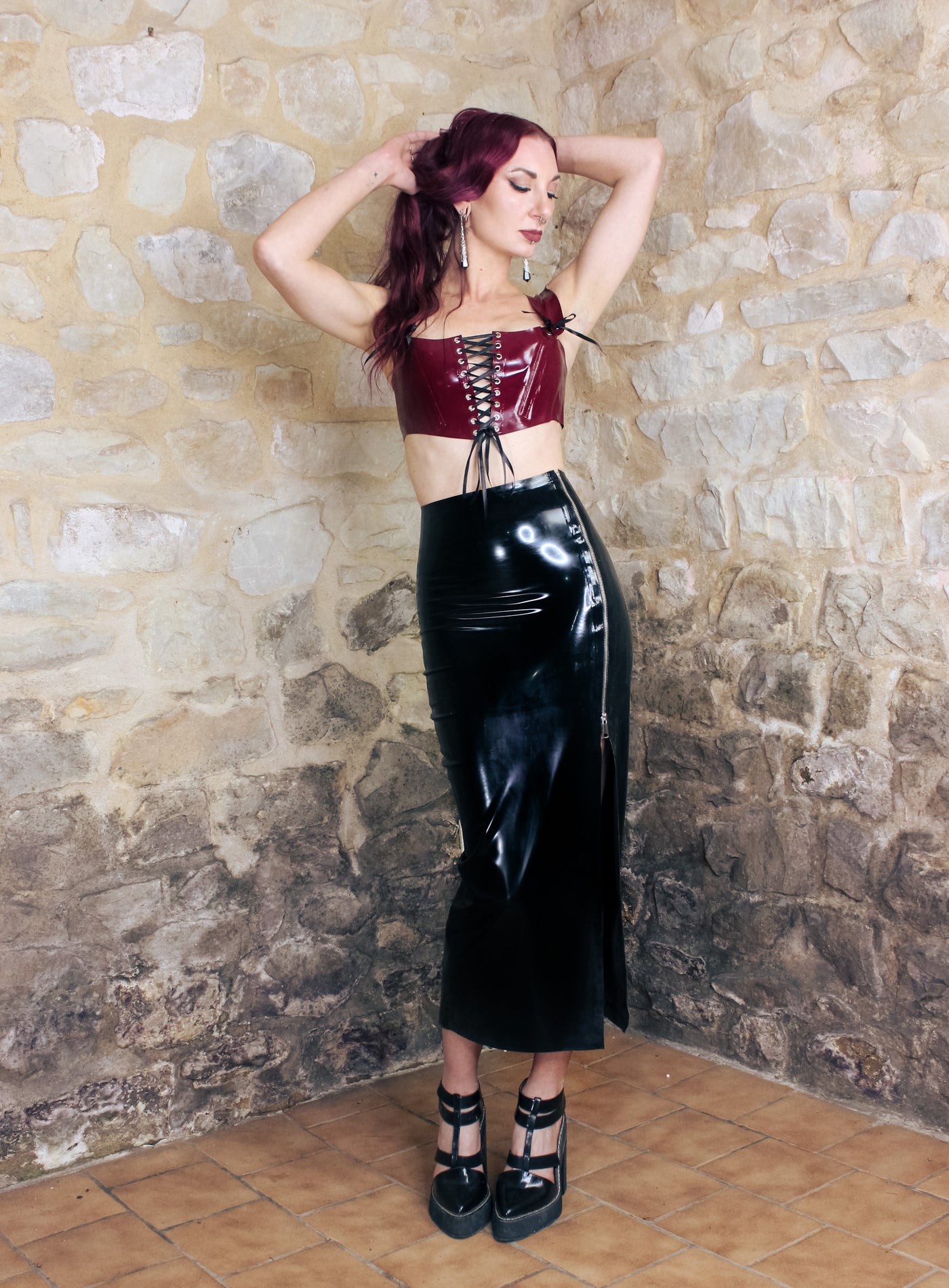 Texture detail of the glossy latex on the cropped corset top