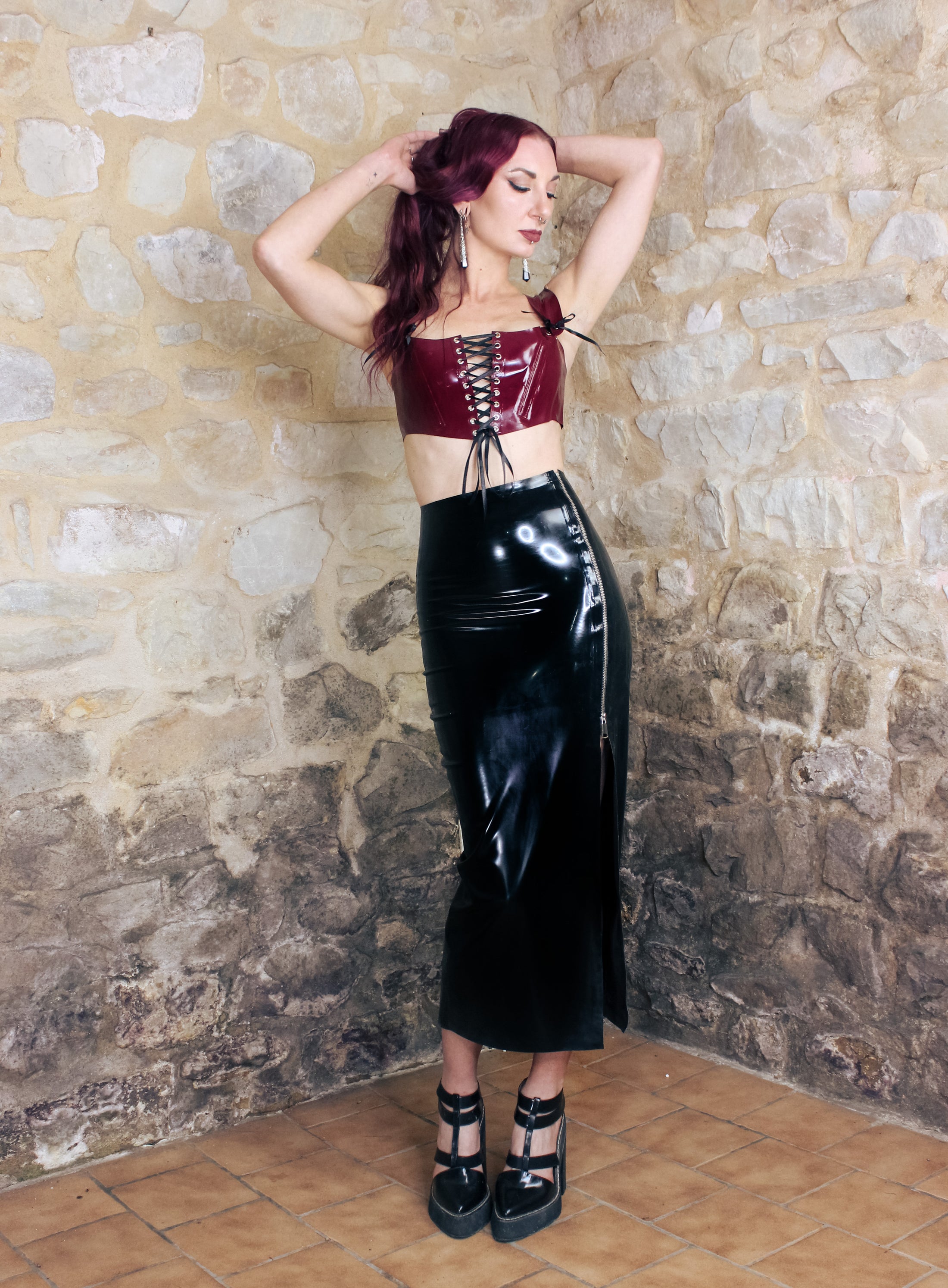 Texture detail of the glossy latex on the cropped corset top