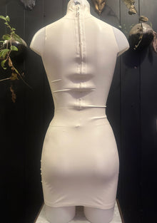 Styling of the white latex cup top and matching mini skirt set
