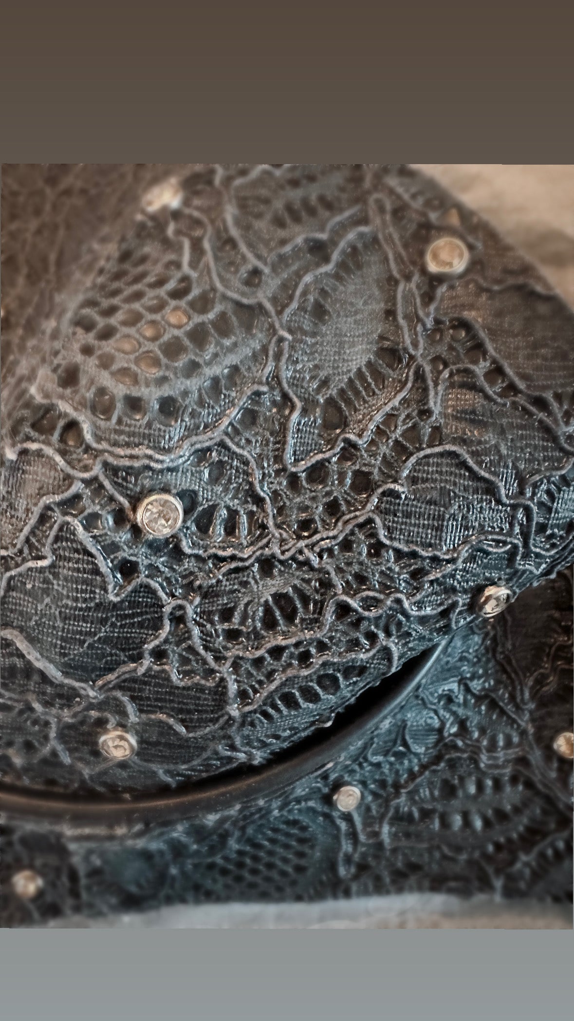 Close detail of the individually embossed latex-lace finish on the statement bra