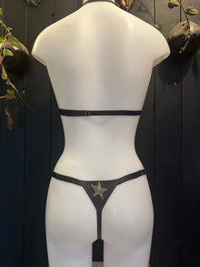 Texture detail of the celestial glitter-mesh latex finish on the adjustable bikini