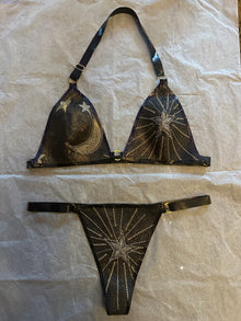 Detail of the shimmering celestial glitter-mesh latex bikini and gold hardware