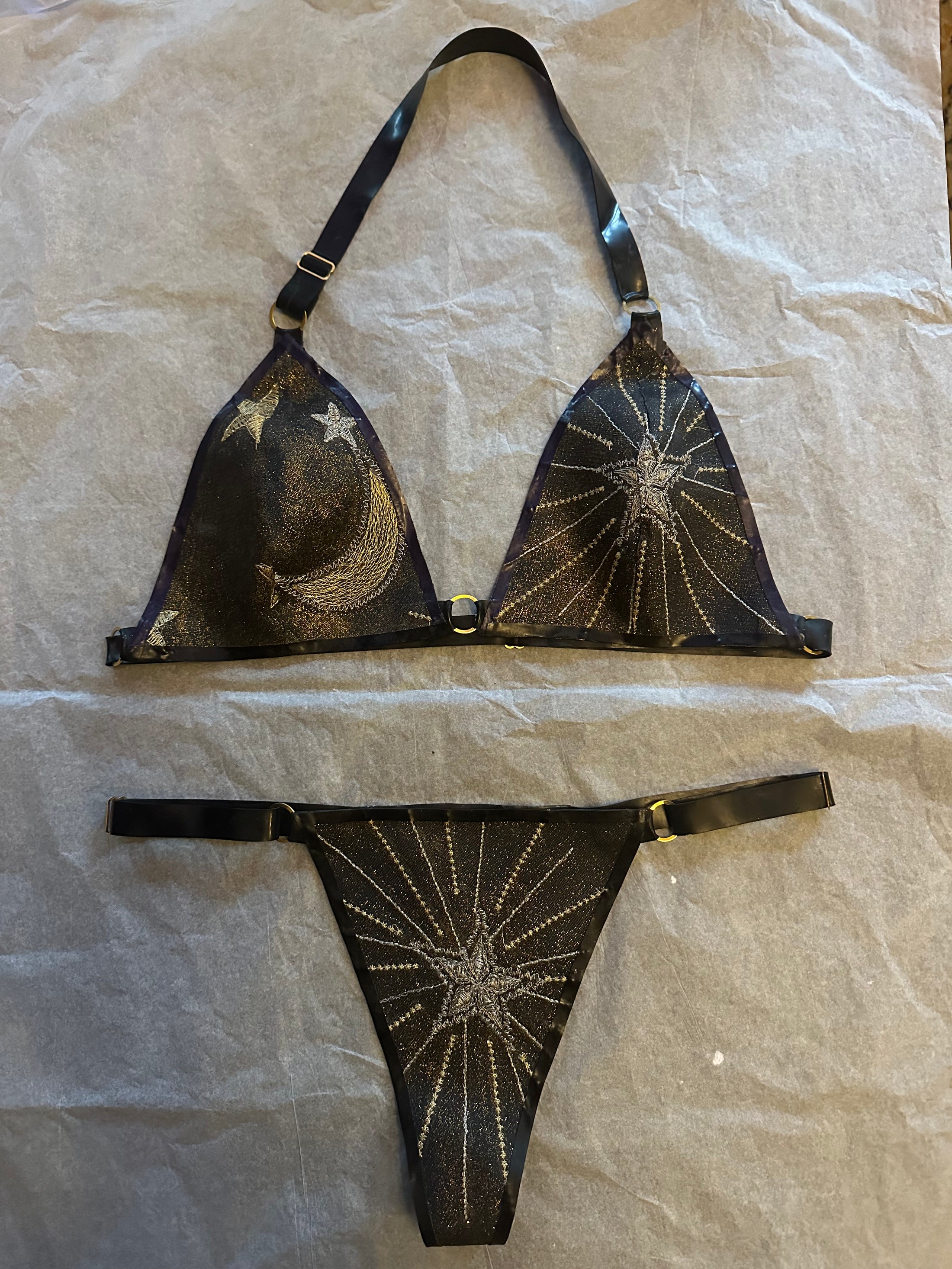 Detail of the shimmering celestial glitter-mesh latex bikini and gold hardware
