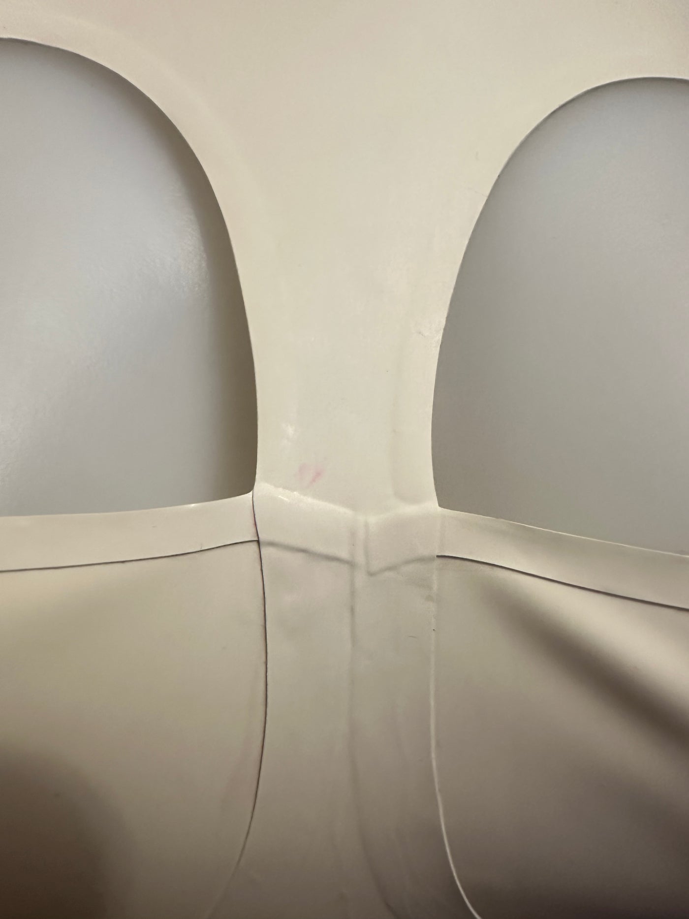 Detail of the white latex cup top showing its fitted shaped cups