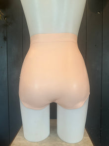Close detail of the trim and waistband on the baby pink latex briefs