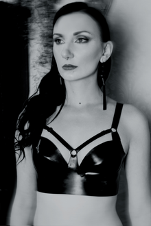 Eustratia underwired latex harness bra with adjustable straps across chest and back