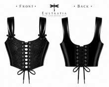 Close detail of the eyelet and lace-up front on the black latex corset top