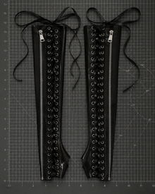 Close detail of the metal zipper feature on the full-length latex gauntlets