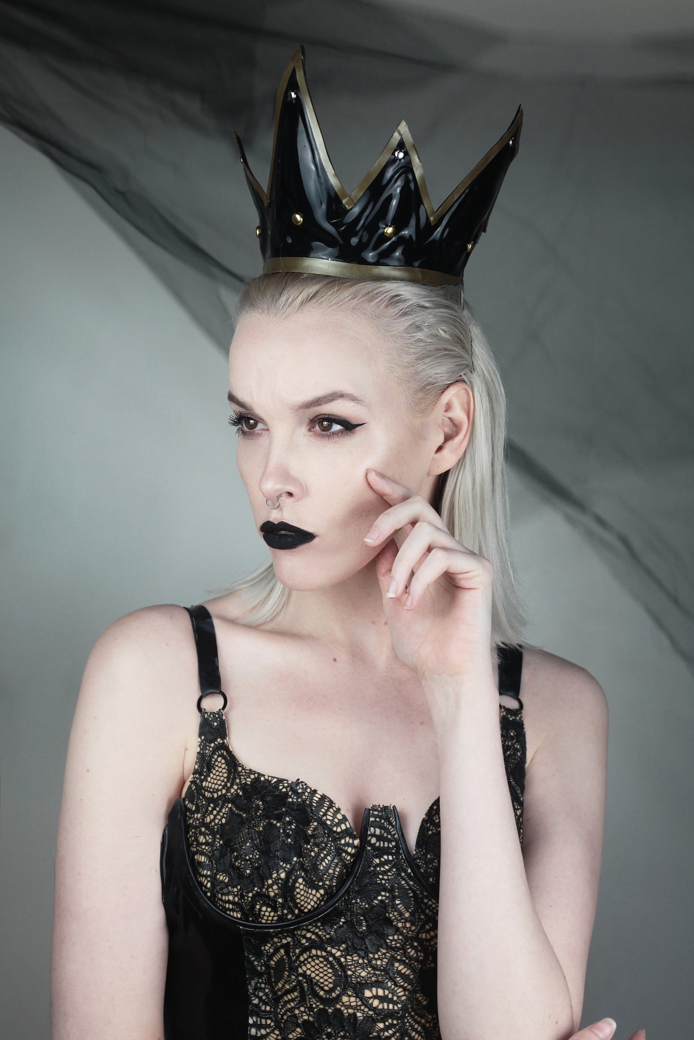 Close detail of the contrast appliqué and studded latex on the dark queen crown