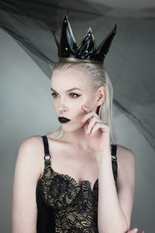 Close detail of the contrast appliqué and studded latex on the dark queen crown