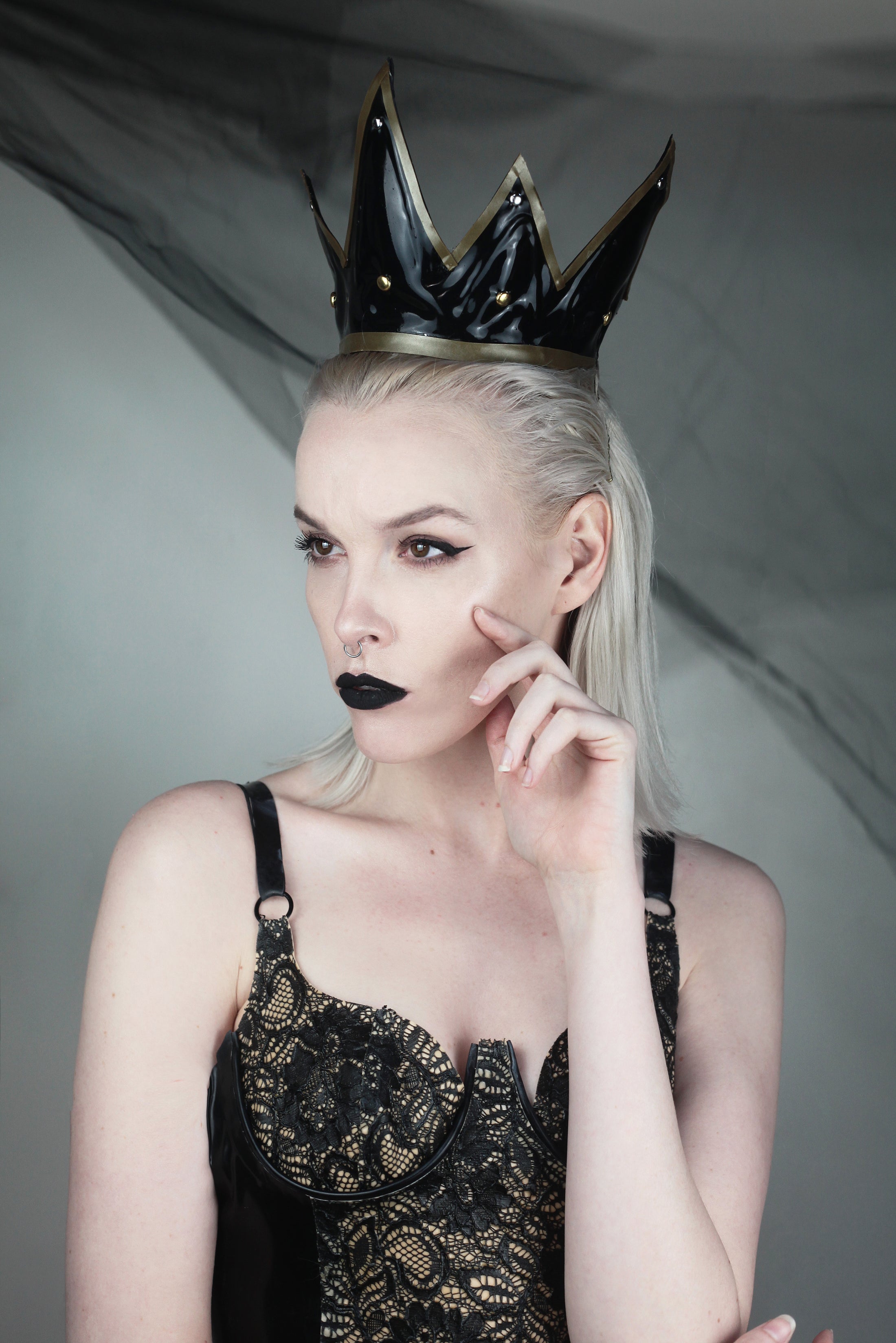 Close detail of the contrast appliqué and studded latex on the dark queen crown