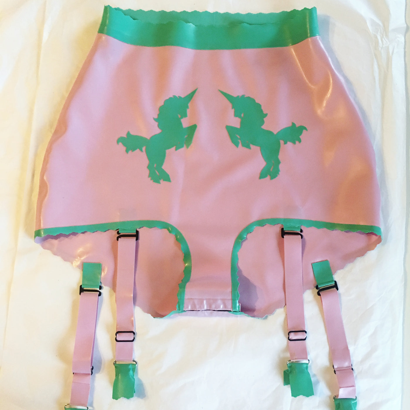 Close detail of the hand-cut unicorn appliques on the high-waisted latex briefs
