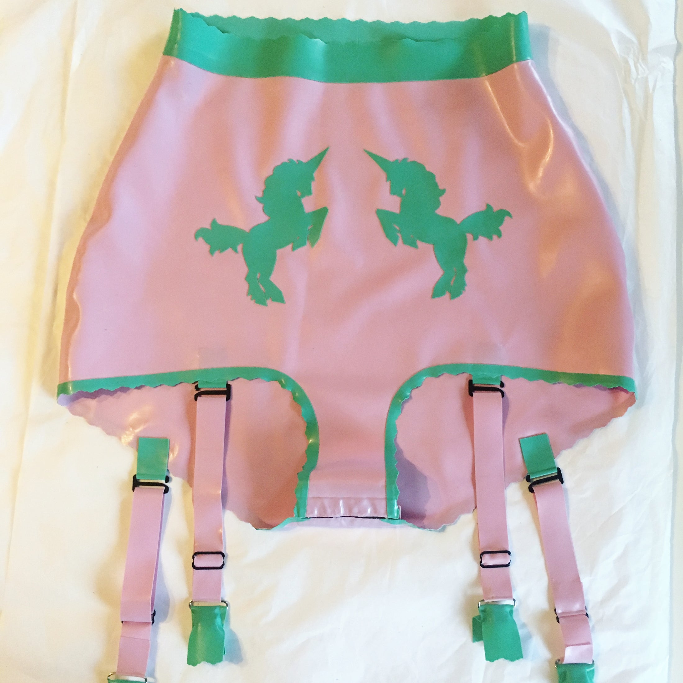 Close detail of the hand-cut unicorn appliques on the high-waisted latex briefs