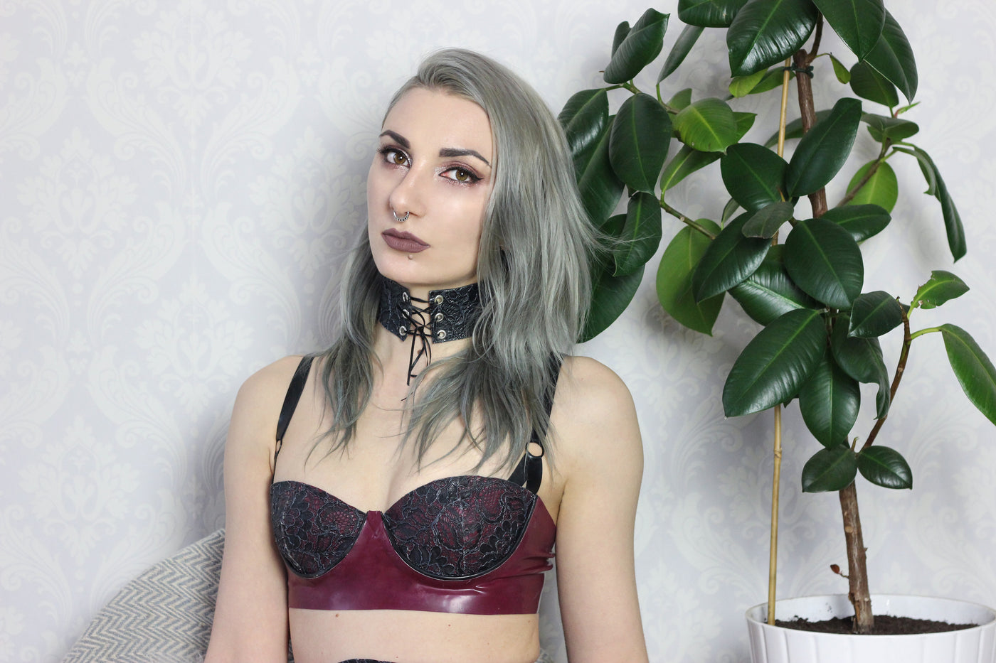 Close detail of the eyelets on the latex-lace choker and cuffs set
