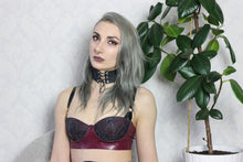 Close detail of the eyelets on the latex-lace choker and cuffs set