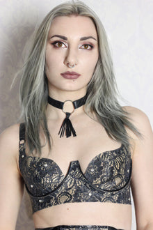 Close detail of the sculptural curvy cup shaping on the latex-lace statement bra