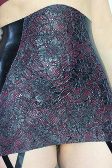 Texture detail of the latex-lace panel on the suspender girdle
