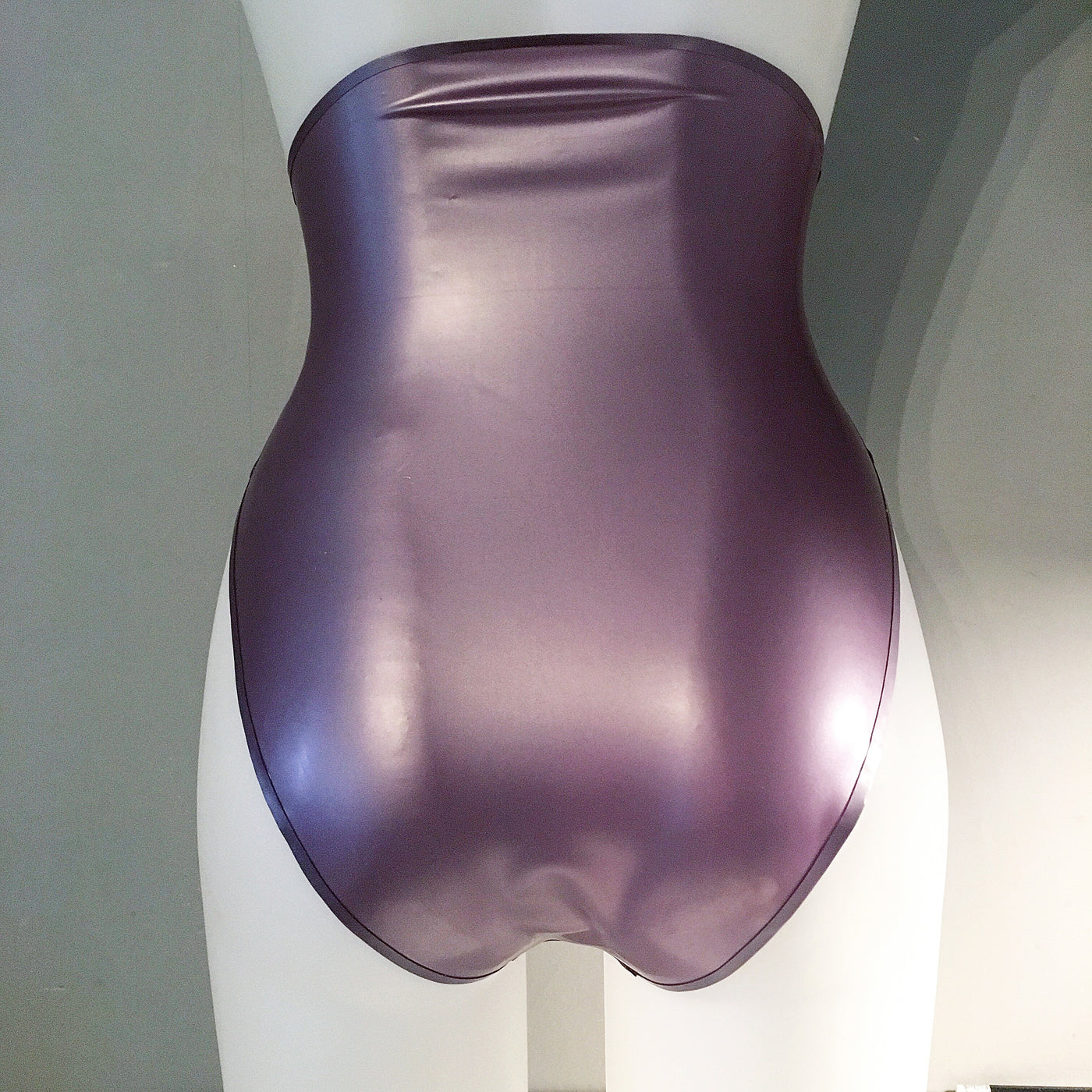 Texture detail of the latex and trim on the high-waisted high-leg briefs