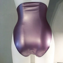 Texture detail of the latex and trim on the high-waisted high-leg briefs