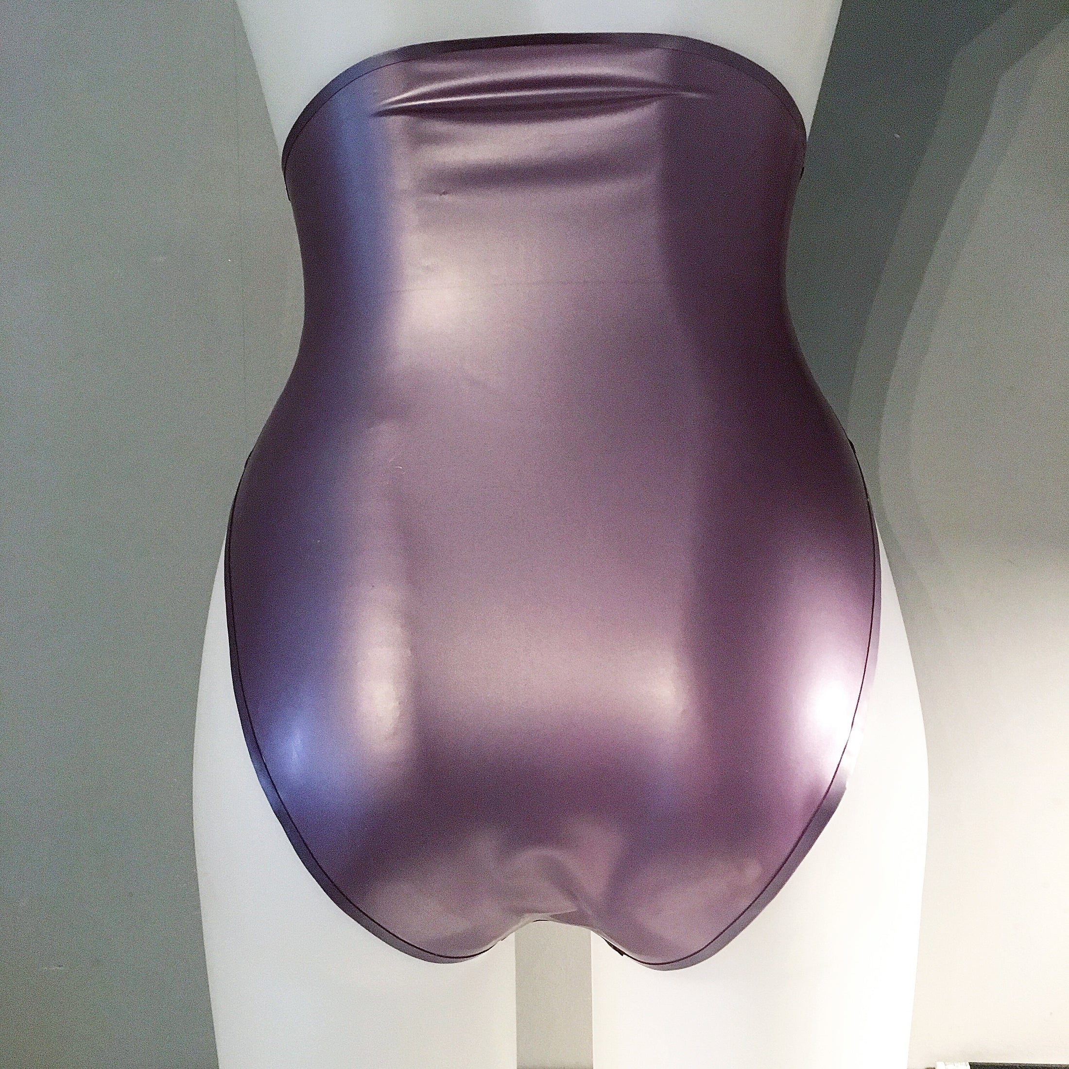Texture detail of the latex and trim on the high-waisted high-leg briefs