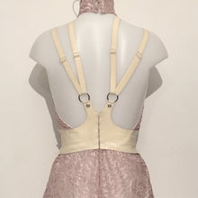 Close detail of the hook and eye back fastening on the latex cincher harness