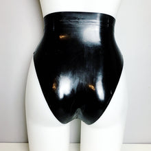 Close detail of the translucent latex briefs with high leg styling
