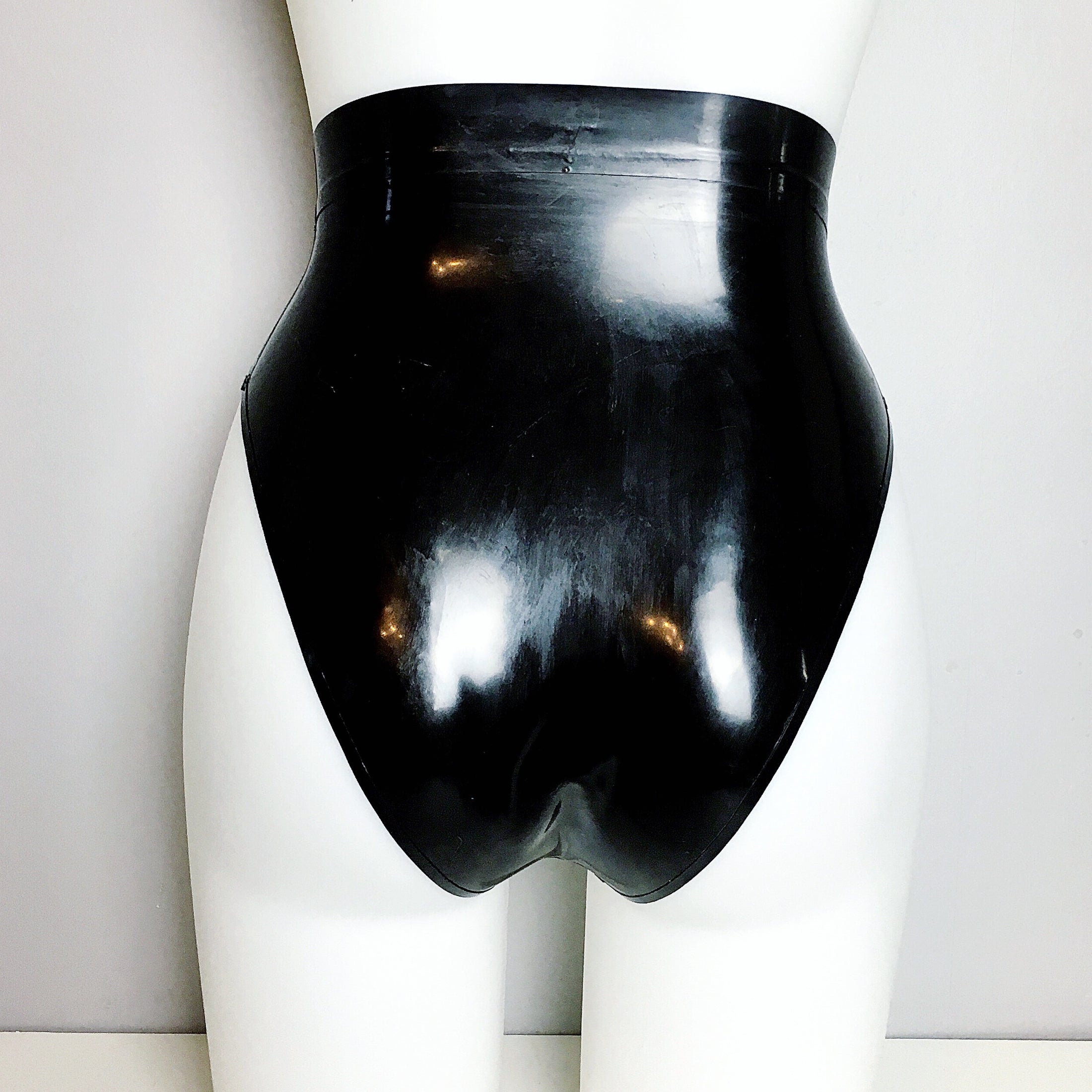 Close detail of the translucent latex briefs with high leg styling