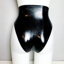 Texture detail of the smooth black latex and trimmed edges on the briefs