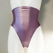 Detail of the high-leg cut and high-waisted shape on the latex briefs