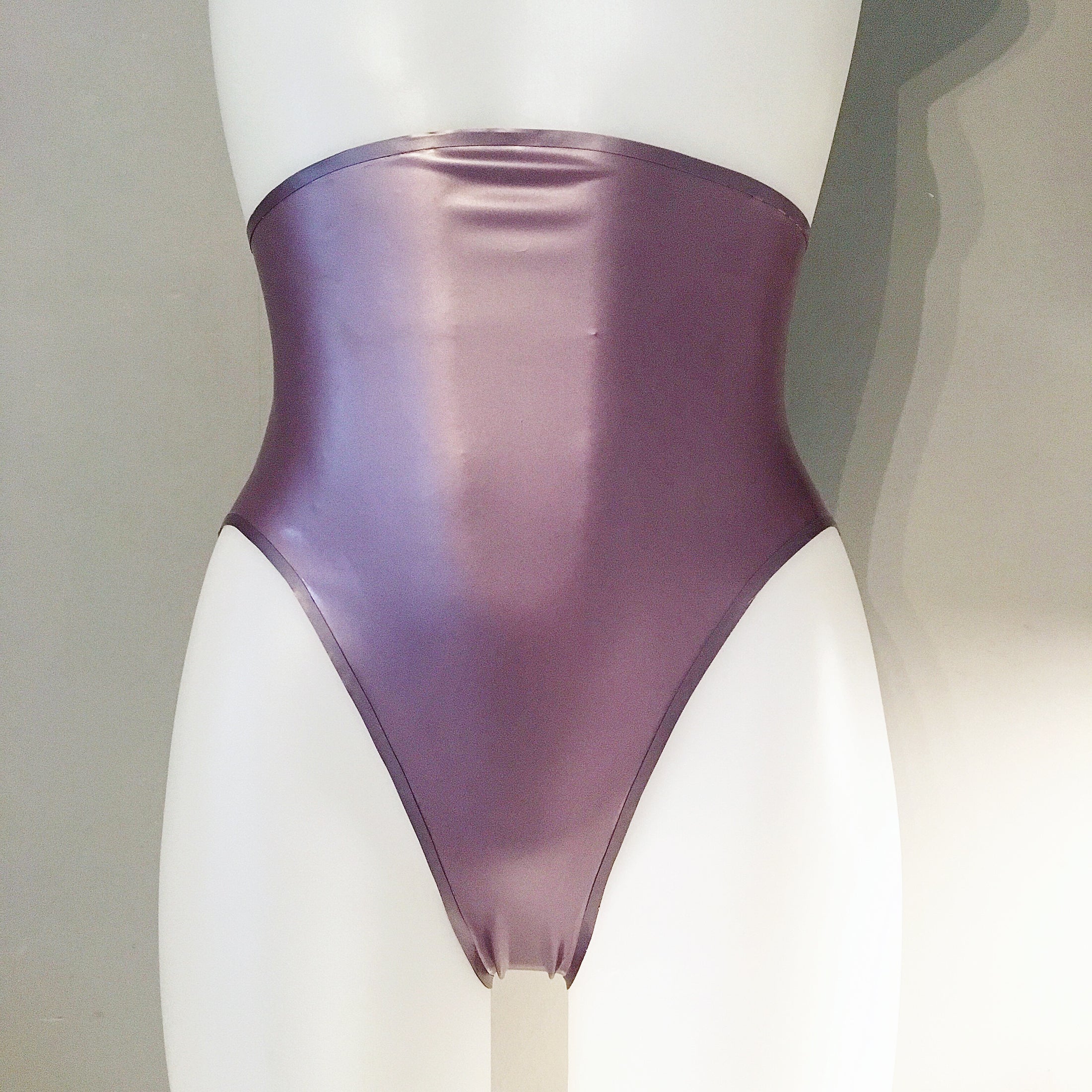 Detail of the high-leg cut and high-waisted shape on the latex briefs