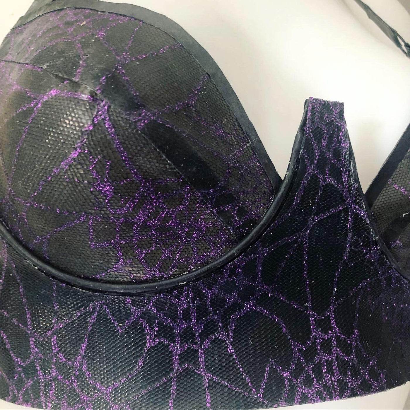 Texture detail of the spiderweb mesh on the latex plunge bra