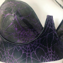 Texture detail of the spiderweb mesh on the latex plunge bra